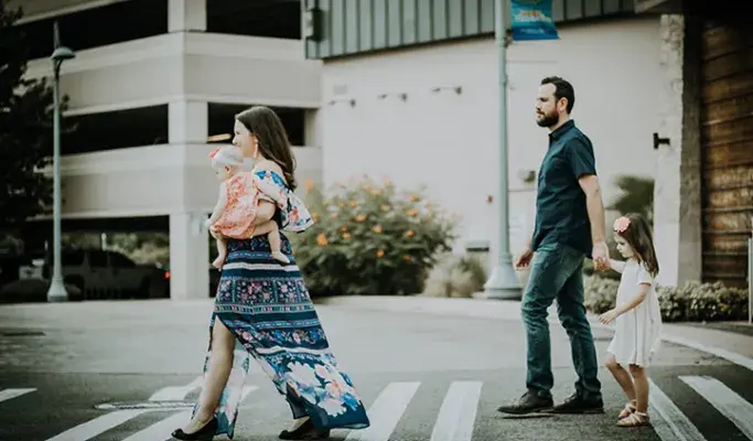 Family walking together across the street.